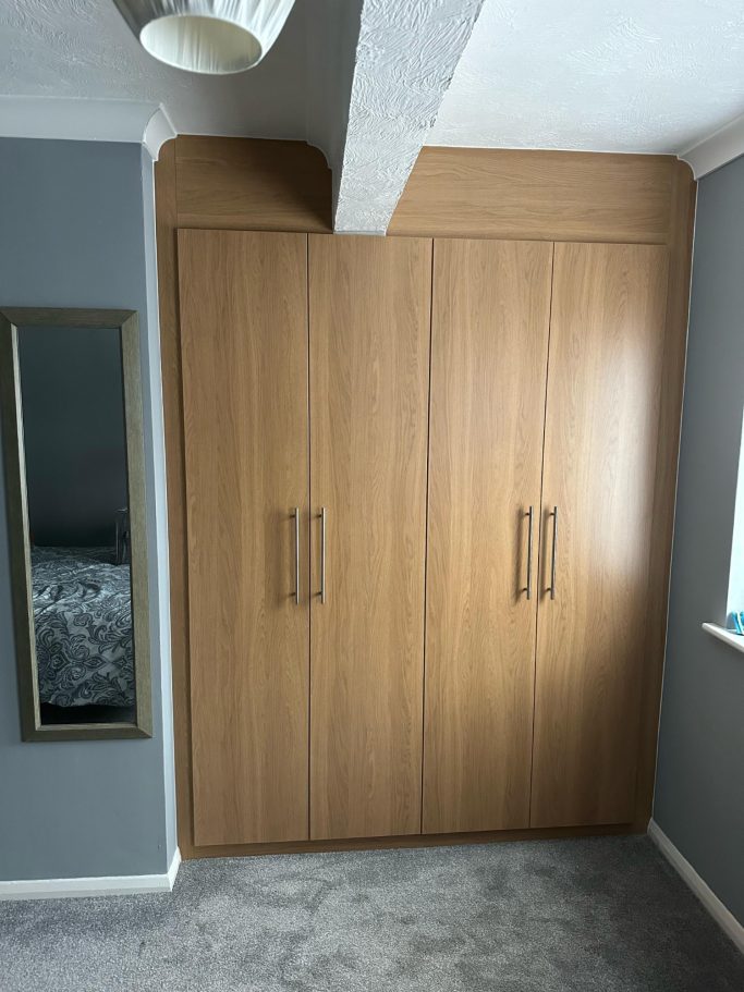4 door bespoke fitted, made to measure wardrobe in Lissa oak in Kent.