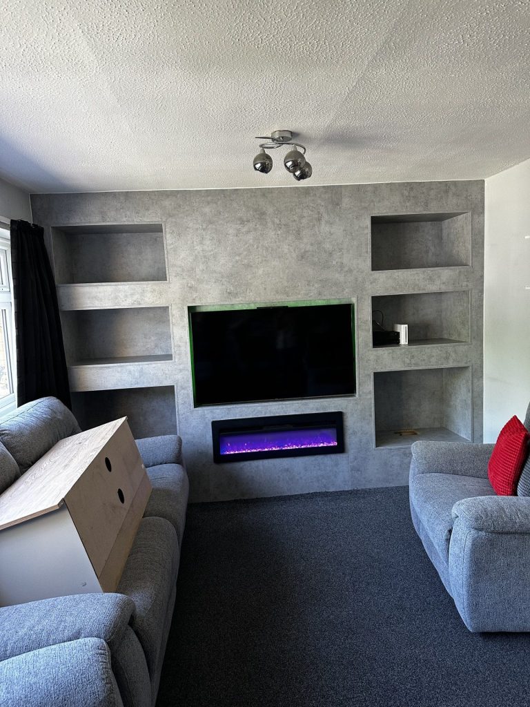 Bespoke fitted media unit in Chicago concrete with fitted fireplace and tv.