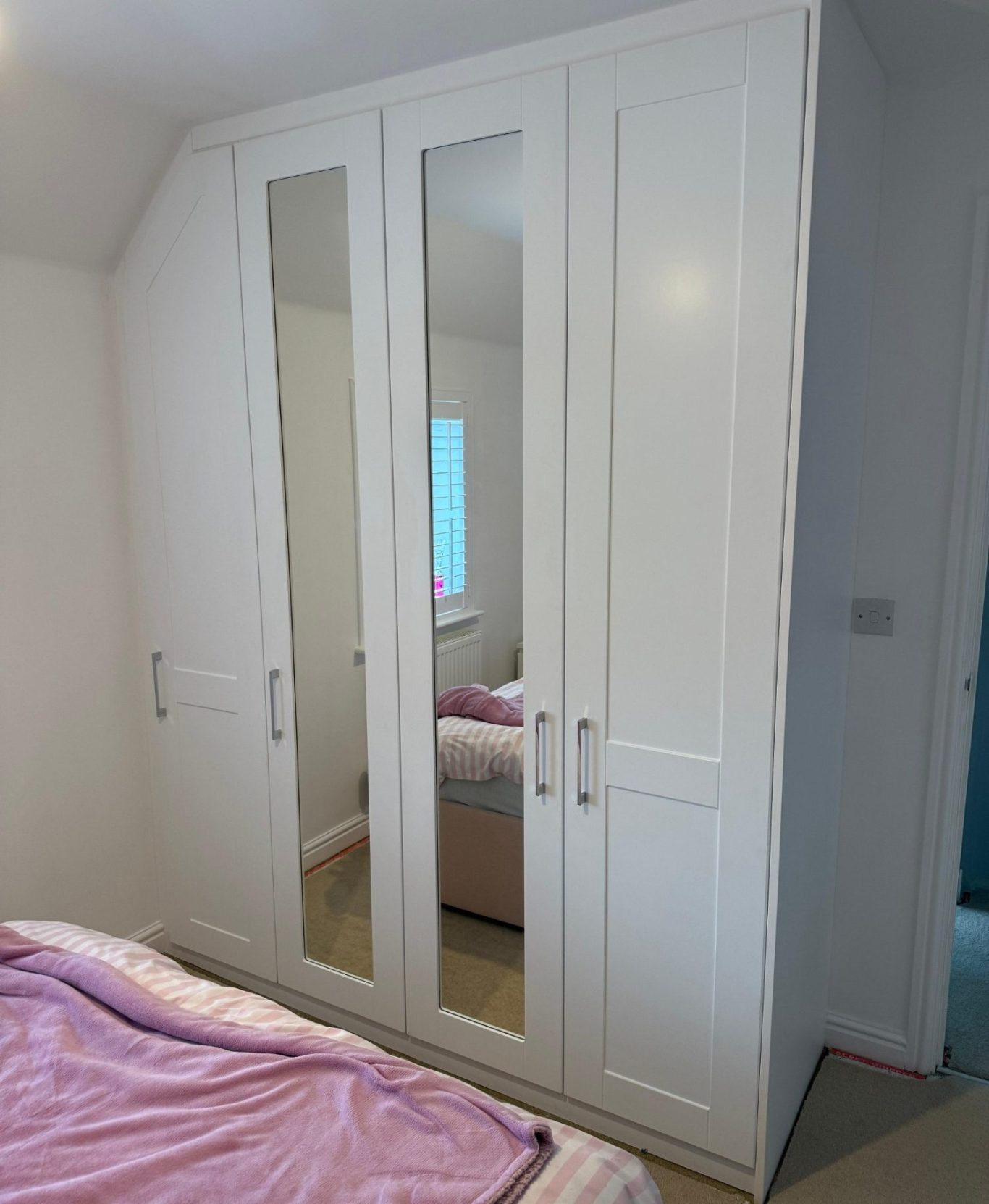 Bespoke fitted angled hinged wardrobe in Chatham, Kent.