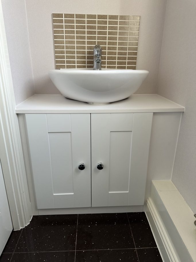 2 door made to measure, bespoke fitted hinged cupboard in frost white, below a sink in Kent.